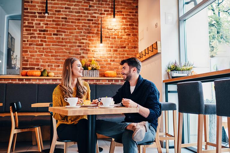 Friends sitting in a cafe together, having a conversation