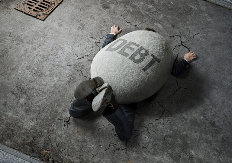 man weighed down by debt