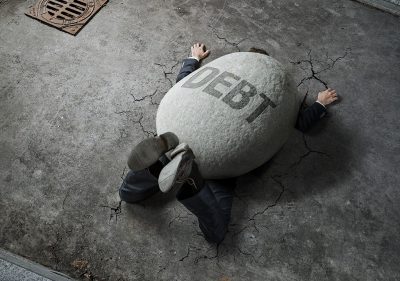 man weighed down by debt